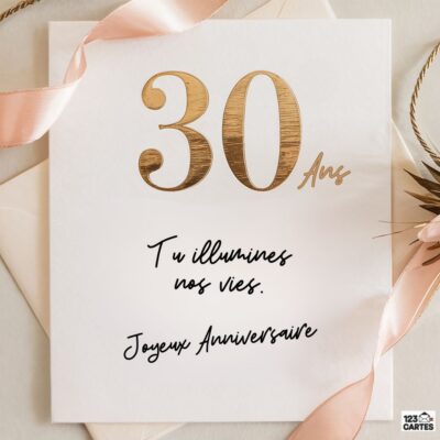 Carte d'anniversaire 30 ans avec chiffres dorés en bois sur fond blanc, rubans roses et texte calligraphié Tu illumines nos vies. Joyeux Anniversaire